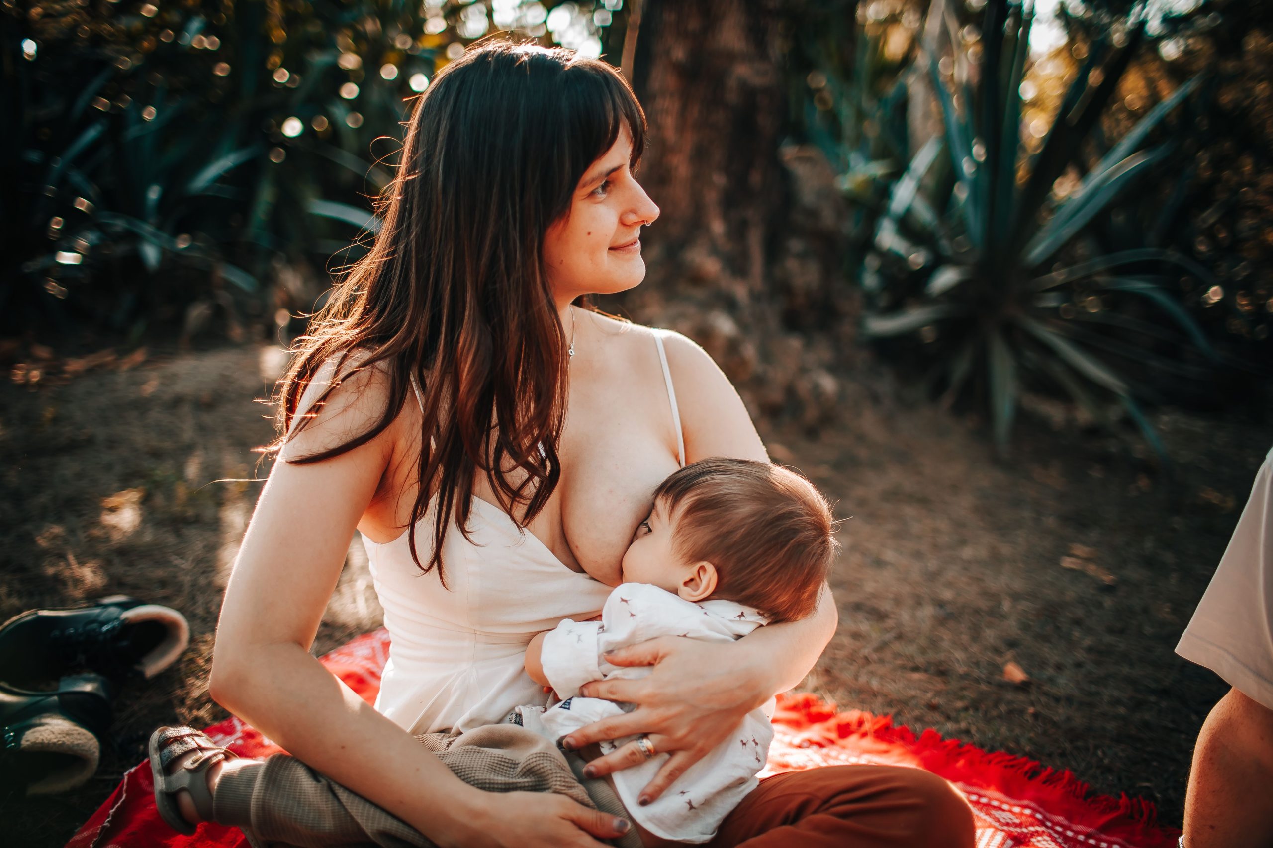 best nursing pillow — parent using a nursing pillow to support baby during feeding