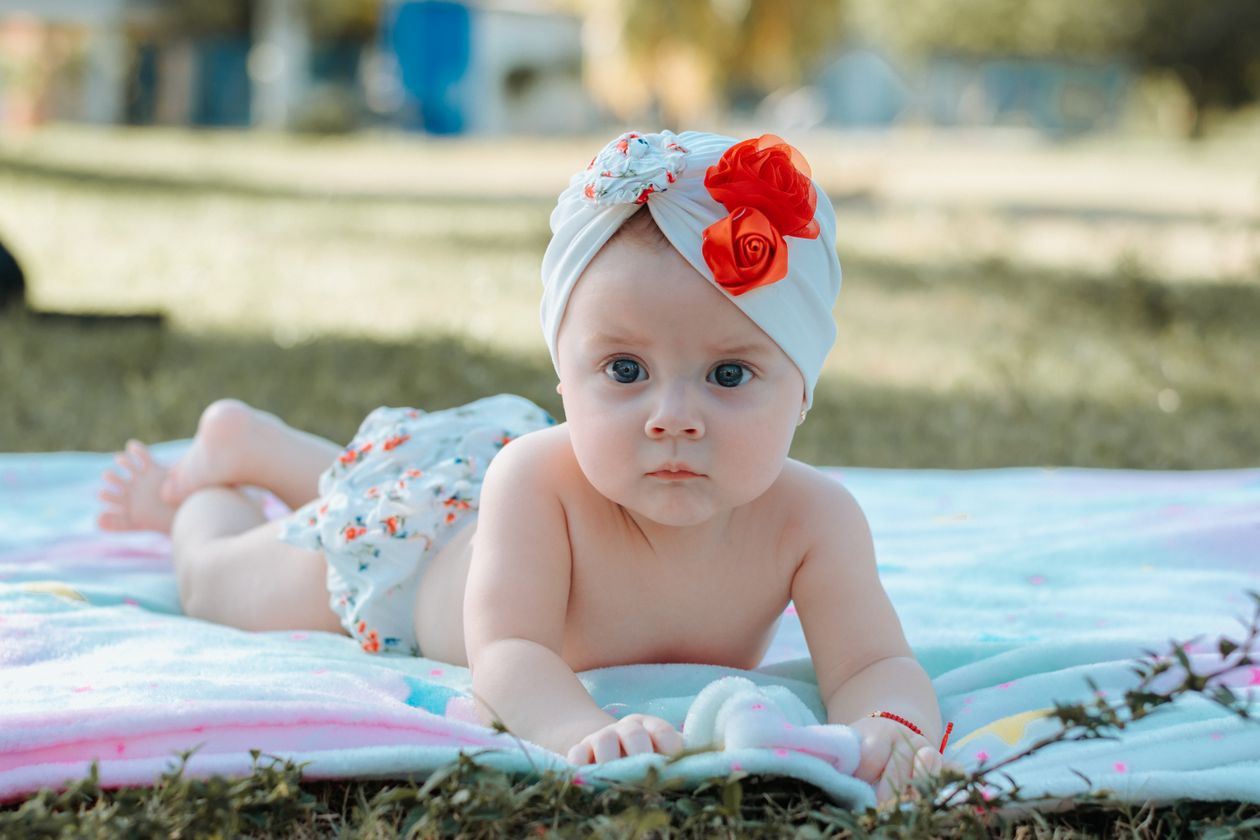 Baby enjoying tummy time on a soft blanket